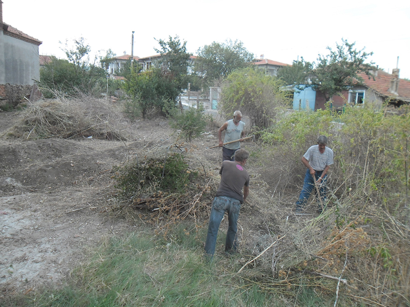 Giorgi, Angel, and Chirstov cleaning the front garden